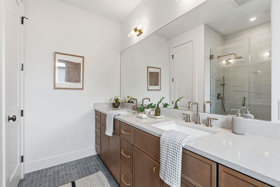 Double vanity with integrated sinks and a light-toned countertop
