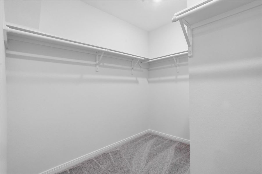 Spacious primary closet with ample storage and built-in shelving. Spacious primary closet with ample storage and built-in shelving.