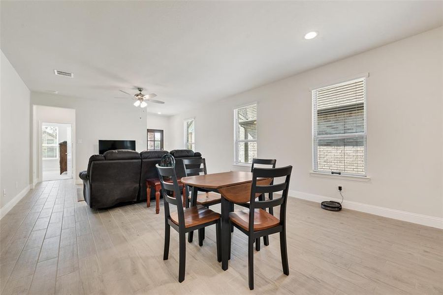 Dining space with light wood-style floors, ceiling fan, and recessed lighting Dining space with light wood-style floors, ceiling fan, and recessed lighting