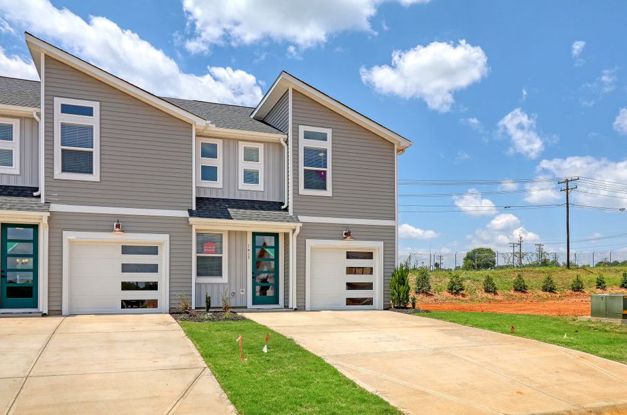 Front exterior of a new home in Westgate Village Townes, Spartanburg, SC, highlighting curb appeal (Image 2). Front exterior of a new home in Westgate Village Townes, Spartanburg, SC, highlighting curb appeal (Image 2).