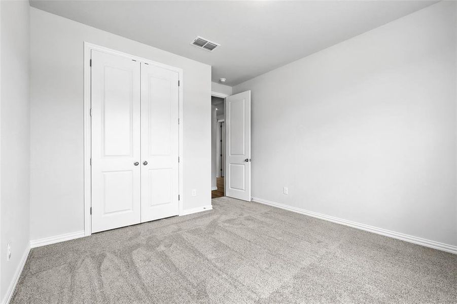 Unfurnished bedroom with carpet floors and a closet
