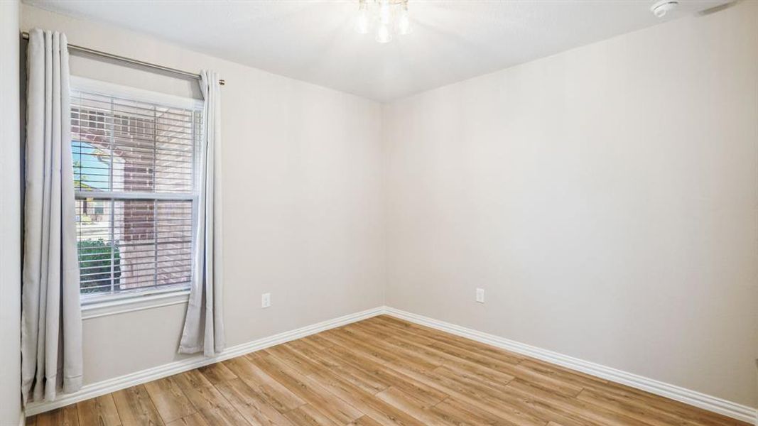 Empty room with light wood finished floors and baseboards Empty room with light wood finished floors and baseboards