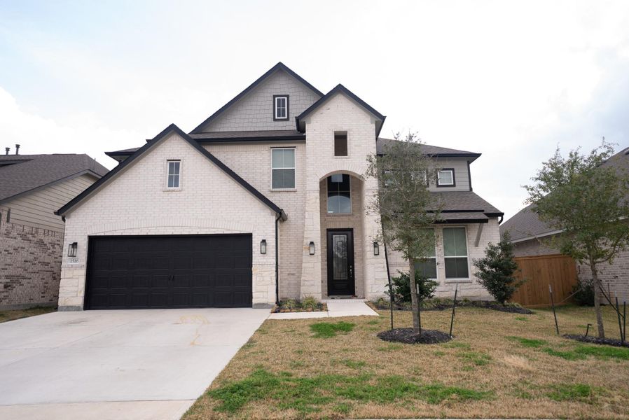 Front exterior of a new home in Sunterra, Katy, TX, highlighting curb appeal (Image 1). Front exterior of a new home in Sunterra, Katy, TX, highlighting curb appeal (Image 1).