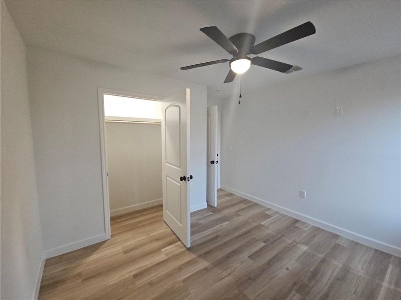 Unfurnished room with visible vents, baseboards, and light wood finished floors