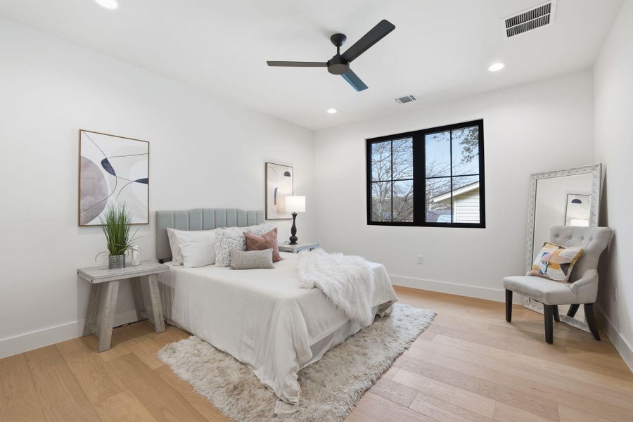 Bedroom featuring light wood-type flooring, ceiling fan, and recessed lighting