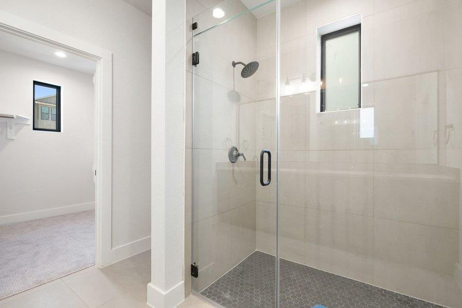Full bath with a shower stall, light tile patterned floors, and recessed lighting