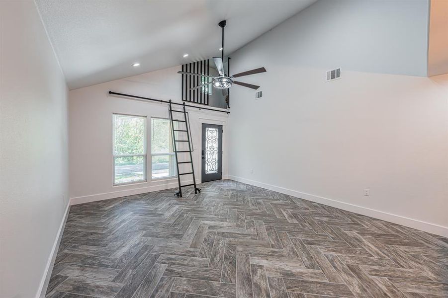 High vaulted ceiling, ceiling fan, and recessed lighting High vaulted ceiling, ceiling fan, and recessed lighting