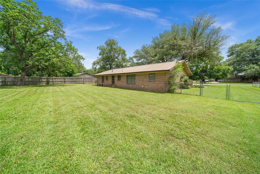 Fenced backyard with a gate