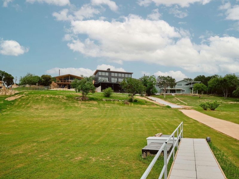 Expansive green lawn with a private dock