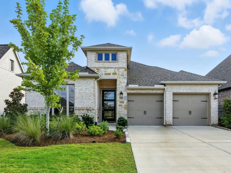 Front exterior of a new home in Artavia 50', Conroe, TX, highlighting curb appeal (Image 1). Front exterior of a new home in Artavia 50', Conroe, TX, highlighting curb appeal (Image 1).