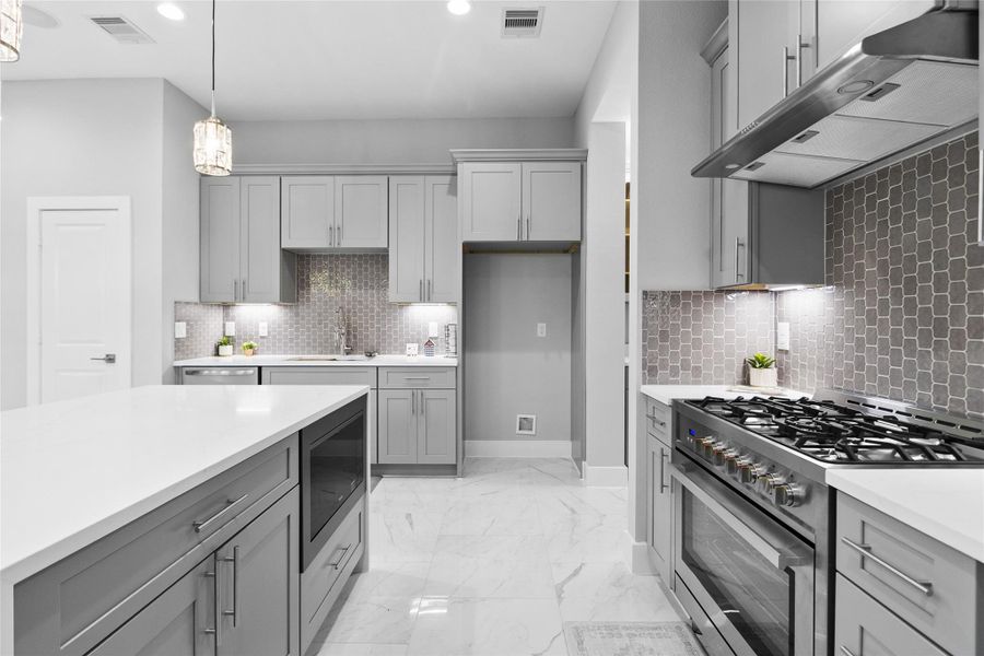 Your chef’s kitchen, with its gas range and bold cabinetry, makes every meal feel like it was prepared in a restaurant-worthy space.