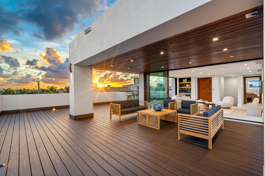 Outside sitting area on the third level with outdoor kitchen, jacuzzi, and firepit.