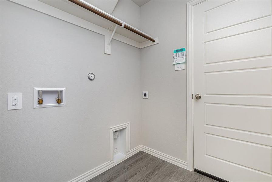 Clothes washing area featuring hookup for an electric dryer, washer hookup, dark hardwood / wood-style flooring, and hookup for a gas dryer