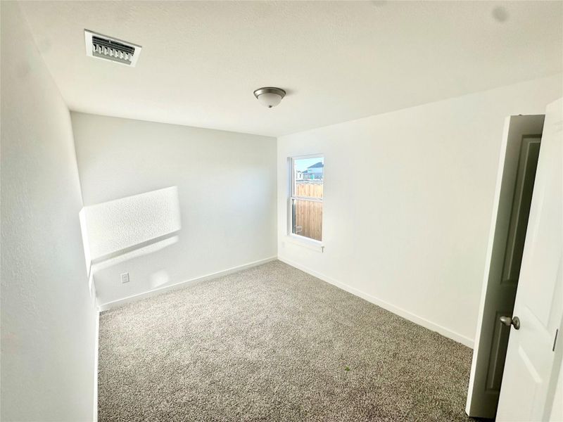 Carpeted empty room featuring baseboards