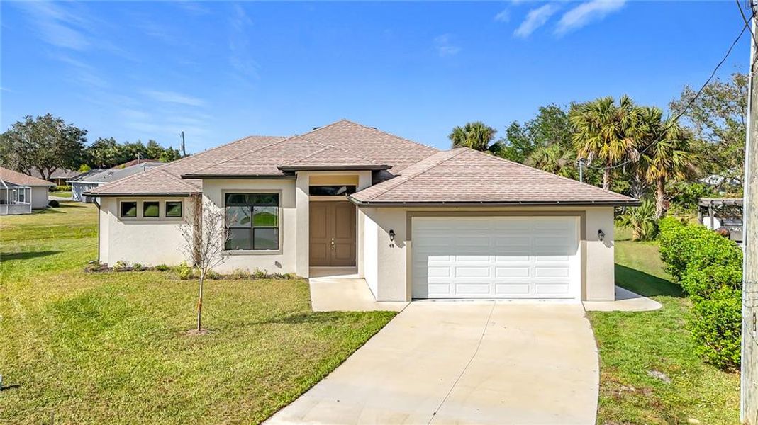 Front exterior of a new home in , Punta Gorda, FL, highlighting curb appeal (Image 1).