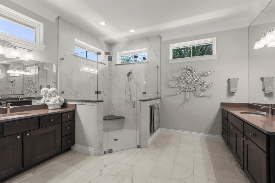 Marble-tiled walk-in shower highlights this generously appointed primary bathroom.
