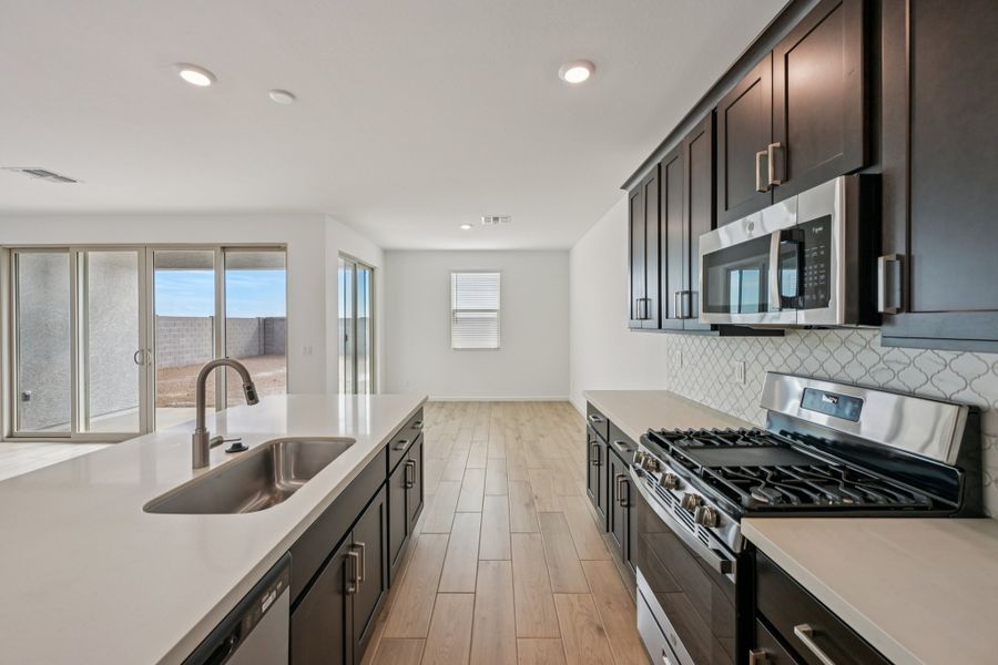 Kitchen and dining. Finishes and options may vary by community