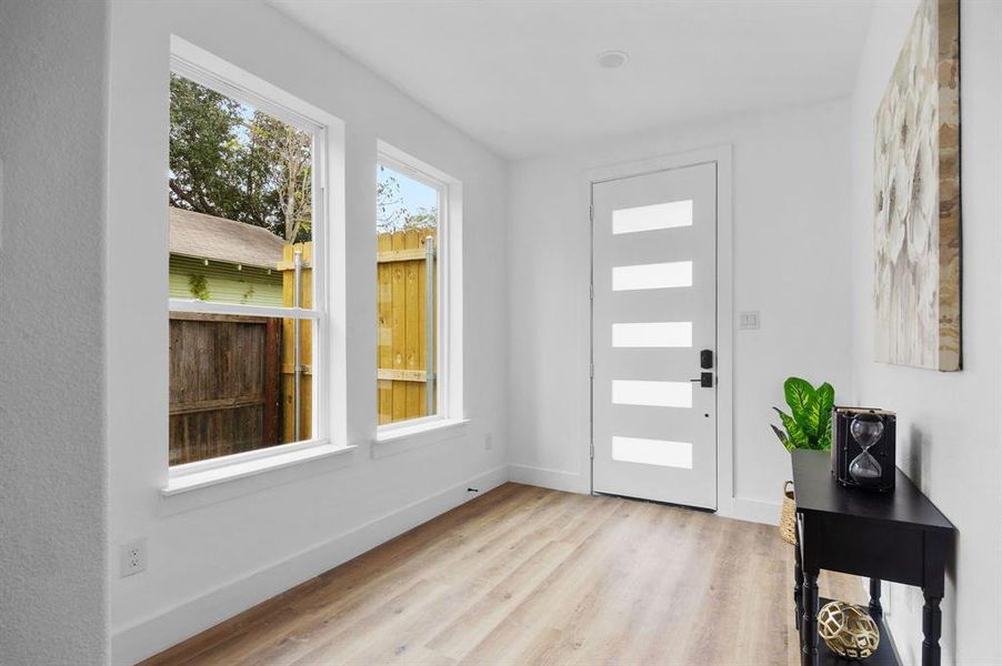 Foyer entrance featuring light hardwood / wood-style floors