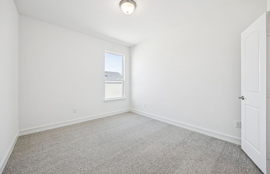 Spacious secondary bedroom with large windows *real home pictured