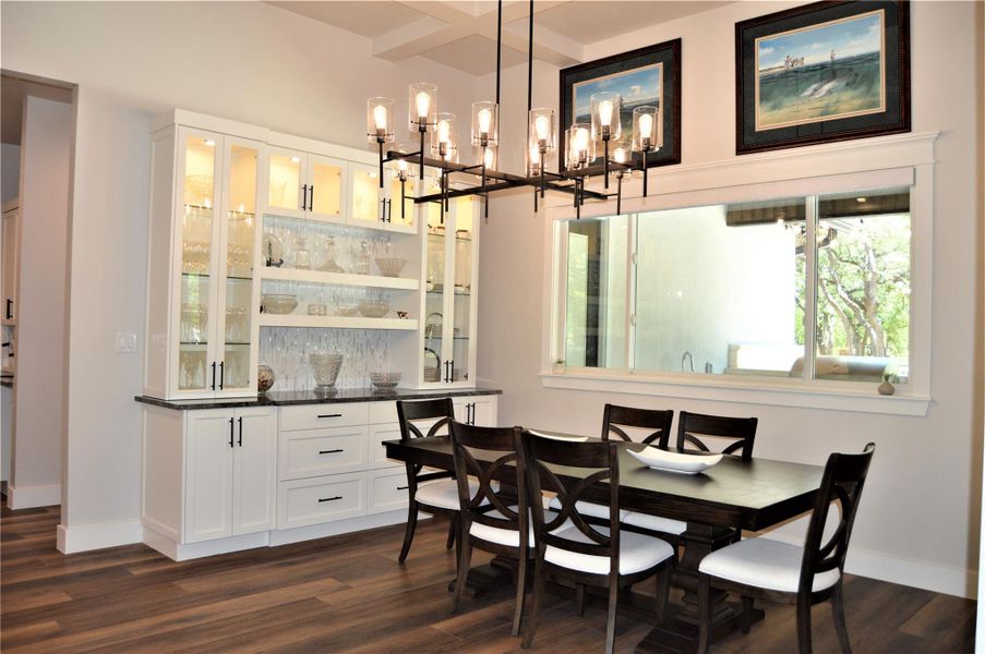 Dining space with a chandelier and beam ceiling Dining space with a chandelier and beam ceiling