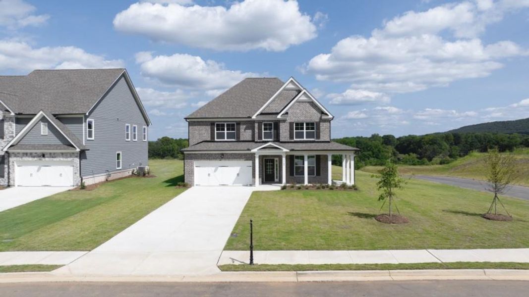Front exterior of a new home in Thalley Creek Estates, Cumming, GA, highlighting curb appeal (Image 1). Front exterior of a new home in Thalley Creek Estates, Cumming, GA, highlighting curb appeal (Image 1).