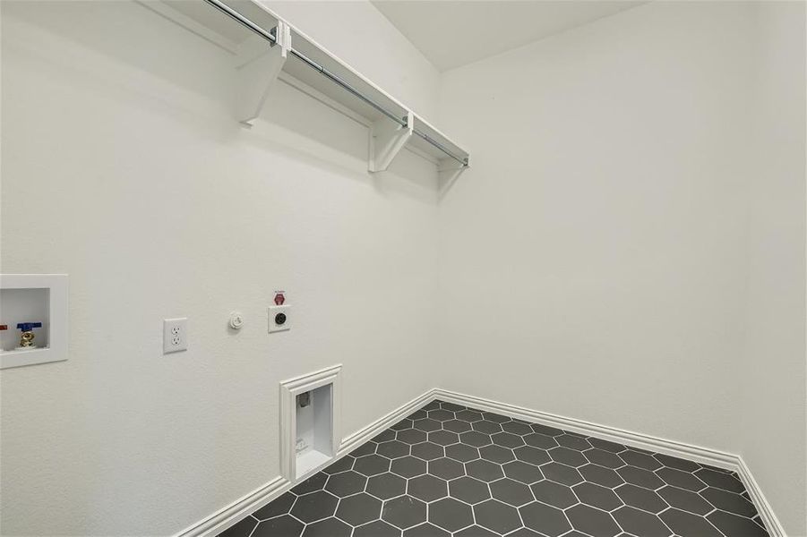 Clothes washing area featuring gas dryer hookup, hookup for a washing machine, tile floors, and hookup for an electric dryer