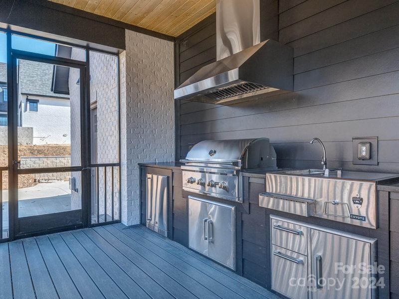 Outdoor Kitchen with Coyote Appliances on Screened in Porch