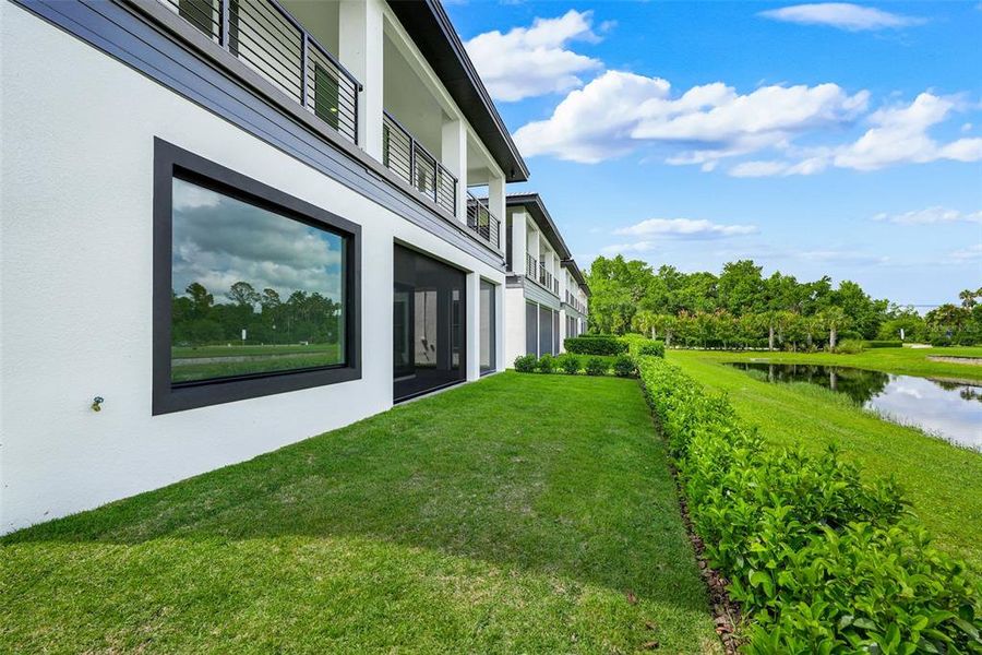 Exterior details and patio area of a home in Hampton Green at Providence, Davenport (Image 36).
