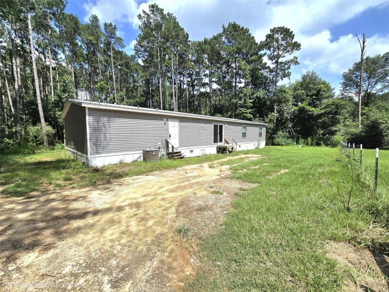 Nestled in a serene, wooded setting, this charming home offers a spacious, private backyard view directly from the driveway, promising tranquility and a connection to nature. Nestled in a serene, wooded setting, this charming home offers a spacious, private backyard view directly from the driveway, promising tranquility and a connection to nature.