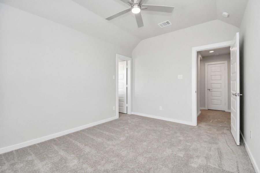 Elegance meets functionality in the generously sized secondary bedrooms, showcasing 5-panel doors with modern hardware, large windows adorned with privacy blinds, and spacious closets boasting sleek and contemporary finishes. Sample photo of completed home with similar floor plan. Actual colors and selections may vary. Elegance meets functionality in the generously sized secondary bedrooms, showcasing 5-panel doors with modern hardware, large windows adorned with privacy blinds, and spacious closets boasting sleek and contemporary finishes. Sample photo of completed home with similar floor plan. Actual colors and selections may vary.