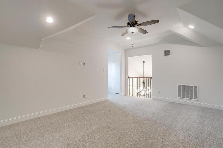 Bonus room with lofted ceiling, ceiling fan, and carpet floors