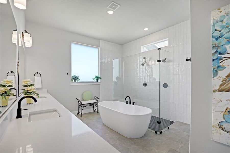 Full bathroom featuring a soaking tub, a walk in shower, recessed lighting, and double vanity Full bathroom featuring a soaking tub, a walk in shower, recessed lighting, and double vanity