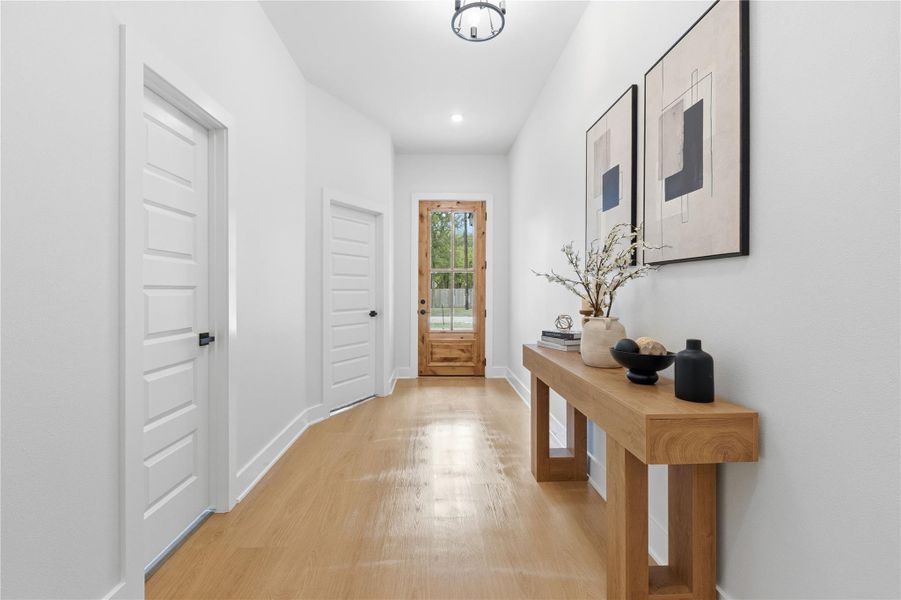 Doorway featuring wood finished floors and recessed lighting
