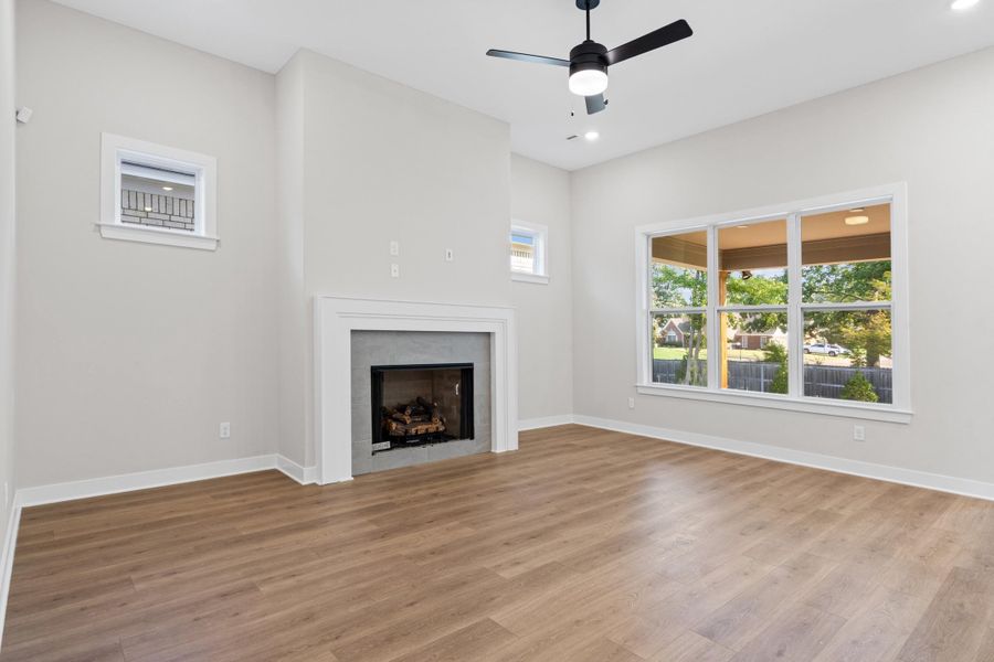 Vaulted ceiling with a black ceiling fan, recessed lighting, and wood-finish flooring Vaulted ceiling with a black ceiling fan, recessed lighting, and wood-finish flooring