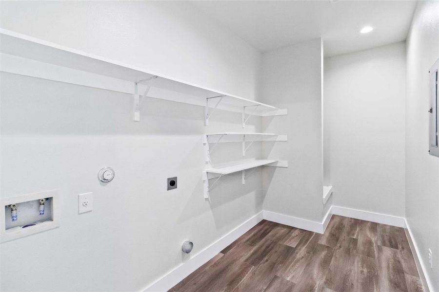 Washroom with gas dryer hookup, dark wood finished floors, hookup for an electric dryer, hookup for a washing machine, and recessed lighting