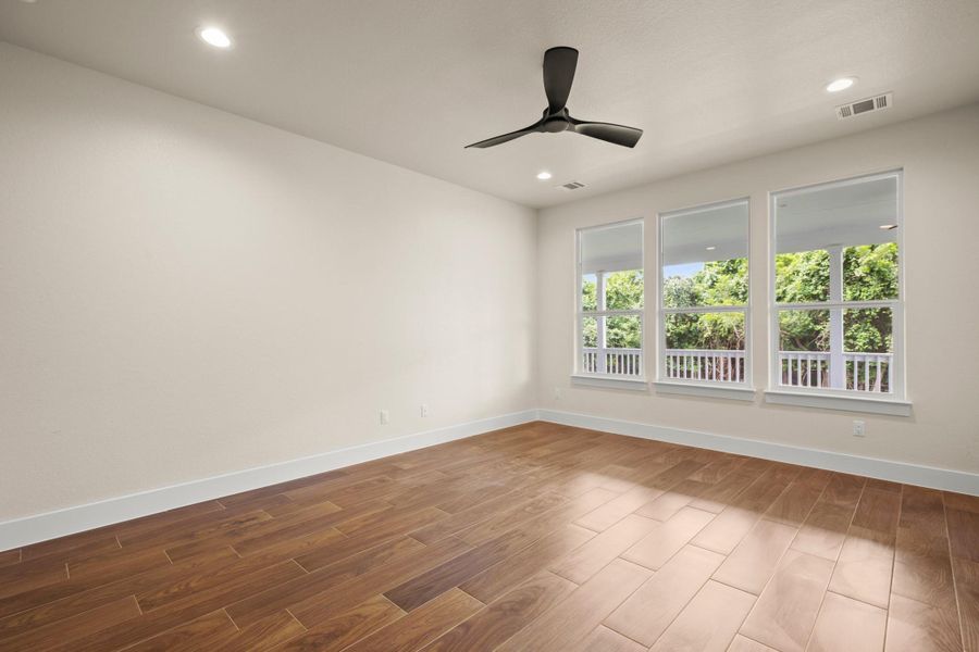 Unfurnished room featuring wood finished floors, ceiling fan, and recessed lighting