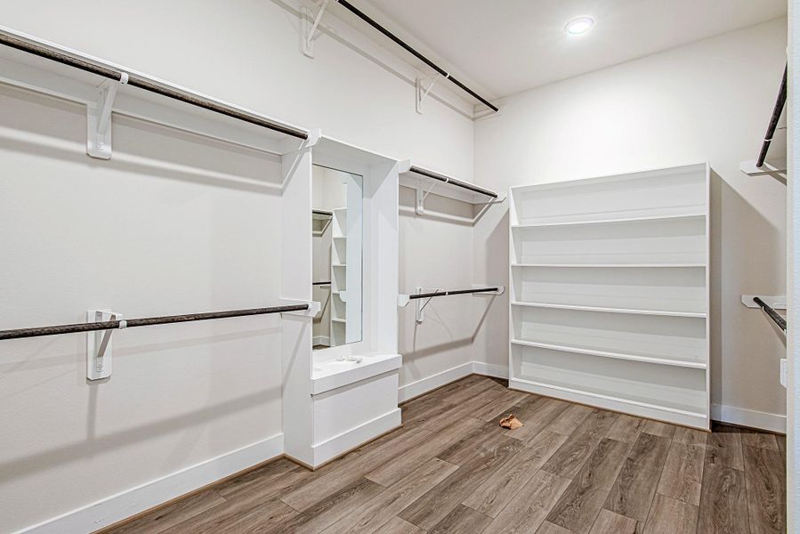Oversized walk-in closet with custom shelving and storage Oversized walk-in closet with custom shelving and storage