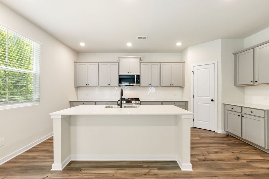 A kitchen with white cabinets. A kitchen with white cabinets.