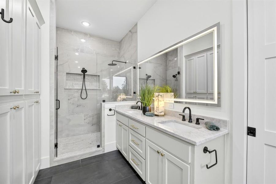 Primary bathroom with walk in shower and separate tub.  Dual dinks and ample cabinets for storage