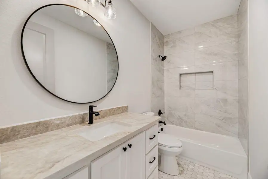 Bathroom with vanity, washtub / shower combination, and tile patterned floors Bathroom with vanity, washtub / shower combination, and tile patterned floors