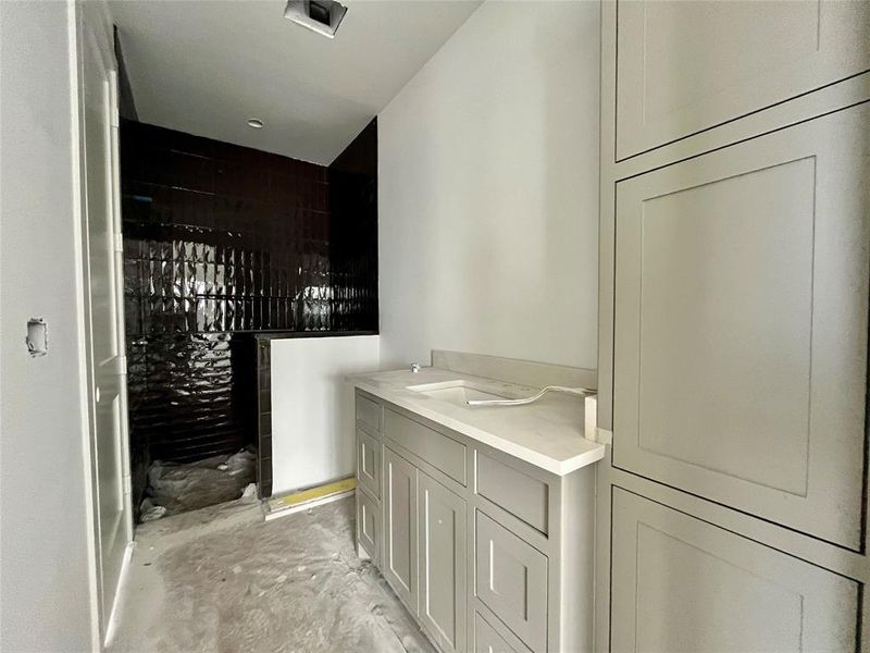 Bathroom featuring sink and concrete floors