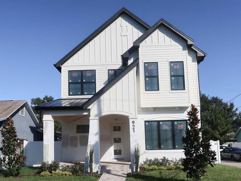 Front exterior of a new home in , St. Petersburg, FL, highlighting curb appeal (Image 1).