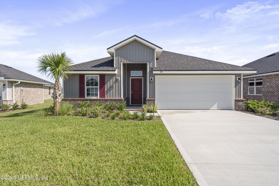 Front exterior of a new home in Shadow Crest at Rolling Hills, Green Cove Springs, FL, highlighting curb appeal (Image 1).