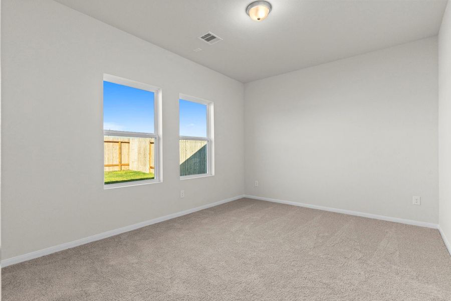 Beautiful primary bedroom retreat with soft carpet flooring and large windows offering peaceful backyard views. The serene color palette and open layout make it the perfect place to relax and unwind. Beautiful primary bedroom retreat with soft carpet flooring and large windows offering peaceful backyard views. The serene color palette and open layout make it the perfect place to relax and unwind.