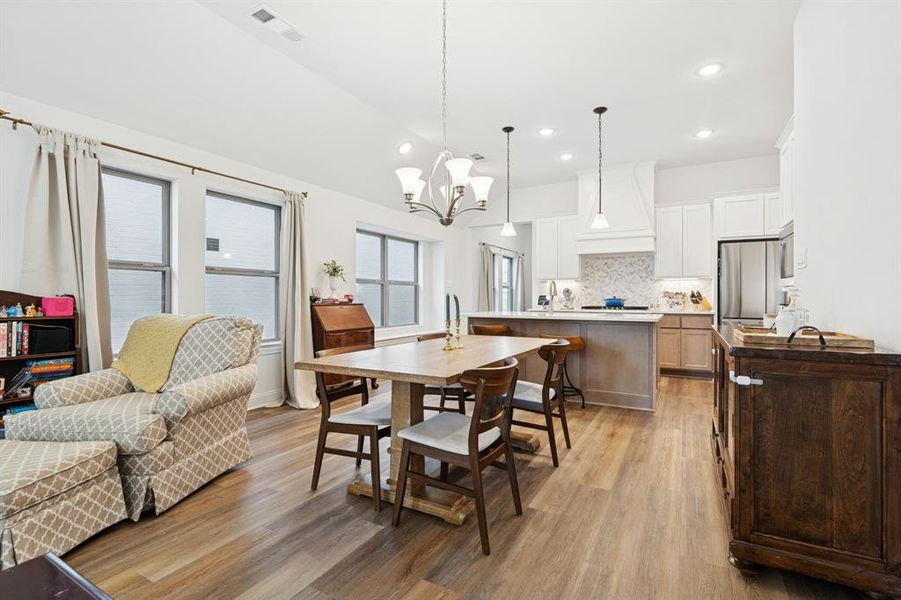 Dining area featuring light wood finished floors, recessed lighting, and a chandelier Dining area featuring light wood finished floors, recessed lighting, and a chandelier