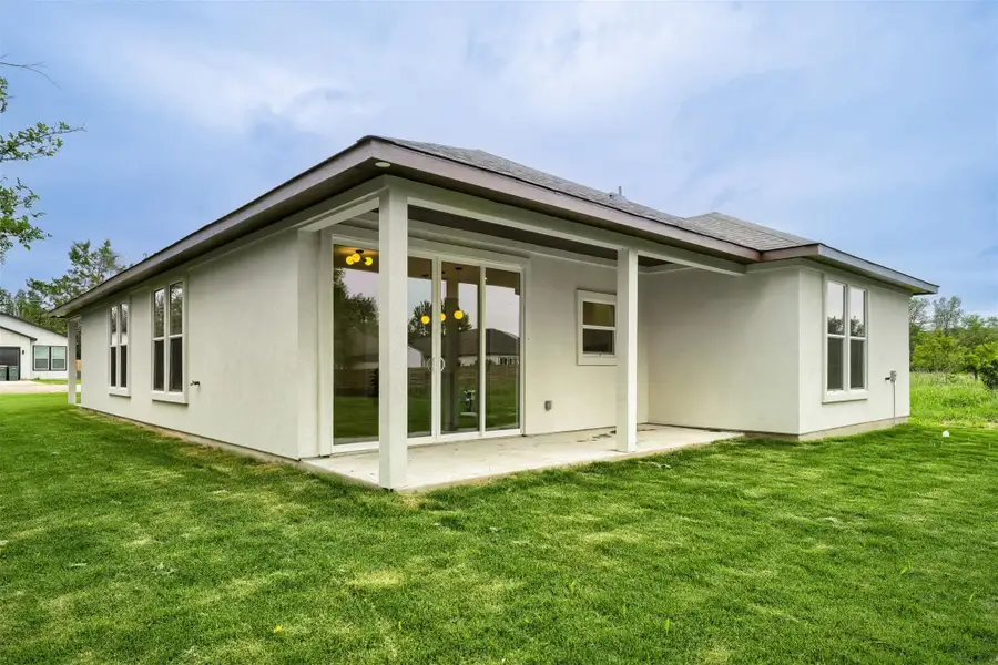 Covered outdoor living area perfect for morning coffee, gatherings, and enjoying the serene setting