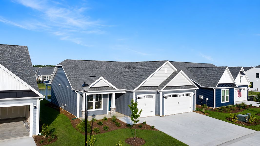 Front exterior of a new home in Bridgewater - Shorehaven Village, Little River, SC, highlighting curb appeal (Image 2). Front exterior of a new home in Bridgewater - Shorehaven Village, Little River, SC, highlighting curb appeal (Image 2).