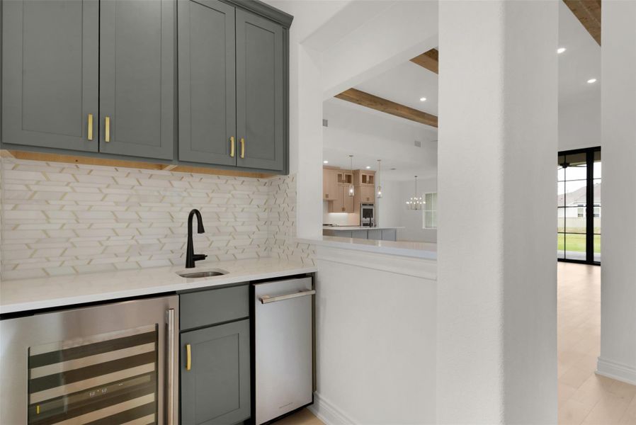 A convenient wet bar offers seamless entertainment, complemented by views into an open-concept living space.