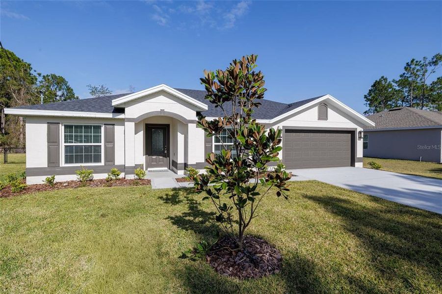 Front exterior of a new home in , Palm Coast, FL, highlighting curb appeal (Image 17).