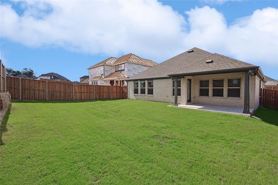 Back of house featuring a patio and a yard